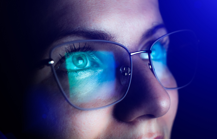 Woman wondering how effective blue-light glasses are while staring up.