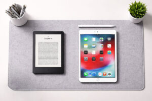 living with macular degeneration supported by a Kindle e reader and iPad on a modern desk at Vantage Eye Center