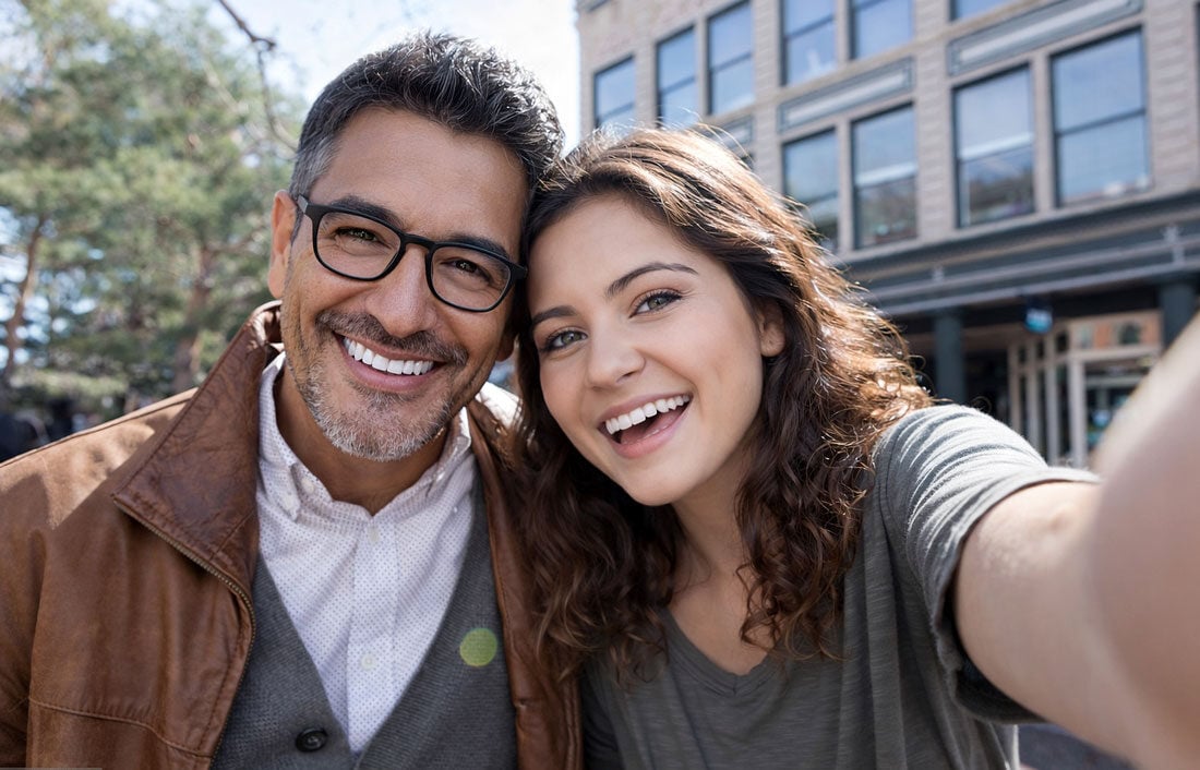 Father and daughter take a selfie in the city after learning more about the causes of blurry vision with Vantage Eye Center.