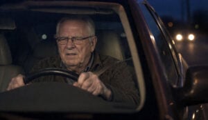Difficulty driving at night is just one way how cataracts affect your vision. Senior man driving with difficulty at night, with Vantage Eye Center.