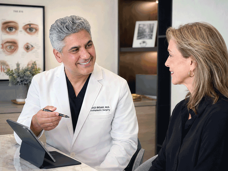 Vantage Eye Center oculofacial specialist discussing Botox and fillers with a female patient in a consultation room.