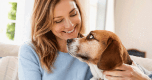 Woman cuddling her dog at home, representing eye allergy treatment for pet owners at Vantage Eye Center.